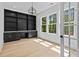 Bright home office with custom built-ins, modern chandelier, and lots of natural light at 400 Auburn Rd, Auburn, GA 30011