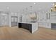 Modern kitchen with an island, pendant lights, stainless steel appliances and white cabinetry at 400 Auburn Rd, Auburn, GA 30011