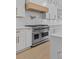 White kitchen featuring high end appliances including a stainless steel range and white subway tile at 400 Auburn Rd, Auburn, GA 30011