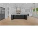 Bright kitchen featuring a large island with a waterfall countertop and modern lighting fixtures at 400 Auburn Rd, Auburn, GA 30011