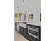 Kitchen island featuring a stainless steel microwave, white farmhouse sink and a modern faucet at 400 Auburn Rd, Auburn, GA 30011
