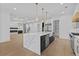 Open kitchen featuring a large island, a stainless steel range, and modern appliances at 400 Auburn Rd, Auburn, GA 30011