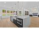 Bright kitchen with a large island featuring a white countertop, stainless steel appliances and a farmhouse sink at 400 Auburn Rd, Auburn, GA 30011