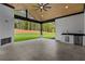 Covered outdoor living space with a fireplace, stainless steel sink, and view of the backyard at 400 Auburn Rd, Auburn, GA 30011