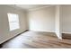 A bedroom with hardwood floors, neutral wall paint and a bright window at 4923 Grizzly Ct, Douglasville, GA 30135
