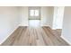 Hallway featuring modern flooring, neutral wall paint, a bright window and white doors at 4923 Grizzly Ct, Douglasville, GA 30135