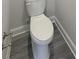 Close-up of a toilet installed on wood-look flooring with white trim at 5331 Tuscany Dr, Douglasville, GA 30135