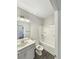 Well-lit bathroom with a sink, shower-tub combination, and wood-look flooring at 5331 Tuscany Dr, Douglasville, GA 30135