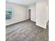 A light and airy bedroom features neutral walls and plush gray carpeting throughout at 5331 Tuscany Dr, Douglasville, GA 30135