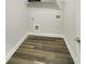 Laundry room with wood-look floors and washer/dryer hookups at 5331 Tuscany Dr, Douglasville, GA 30135