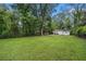 Expansive backyard featuring a well-maintained lawn, mature trees, and a view of the home's exterior at 581 Taylor Se Dr, Smyrna, GA 30080