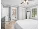 Inviting bedroom featuring wood floors, a ceiling fan, and access to an ensuite bathroom at 581 Taylor Se Dr, Smyrna, GA 30080