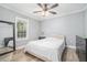 Cozy bedroom with wood-look floors, neutral walls, ceiling fan, and ample natural light at 581 Taylor Se Dr, Smyrna, GA 30080