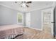 Neutral bedroom featuring hardwood floors, a ceiling fan, and a view into the hallway at 581 Taylor Se Dr, Smyrna, GA 30080