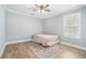 Cozy bedroom with wood floors, a colorful rug, and ample natural light from the window at 581 Taylor Se Dr, Smyrna, GA 30080