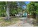 Charming home featuring a bright blue front door, wood shutters and mature trees at 581 Taylor Se Dr, Smyrna, GA 30080