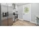 Well-lit kitchen with stainless steel appliances, white cabinets, and wooden floors at 581 Taylor Se Dr, Smyrna, GA 30080