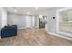Open-concept living area with wood floors leading to a modern kitchen and white trim at 581 Taylor Se Dr, Smyrna, GA 30080