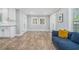 Inviting living room featuring wood floors, natural light, and a comfortable blue sofa at 581 Taylor Se Dr, Smyrna, GA 30080