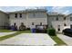 A townhouse featuring a backyard with private parking spots, deck, and beige siding at 162 Odyssey Turn, Conyers, GA 30012