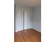 Bedroom with hardwood flooring, a closet and neutral paint at 162 Odyssey Turn, Conyers, GA 30012