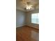 Sunlit bedroom featuring hardwood flooring and a ceiling fan for added comfort at 162 Odyssey Turn, Conyers, GA 30012