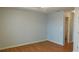 Bright bedroom with hardwood floors featuring a ceiling fan and an ensuite bath at 162 Odyssey Turn, Conyers, GA 30012