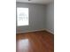 Bedroom with hardwood floors featuring a sunny window and neutral paint at 162 Odyssey Turn, Conyers, GA 30012