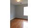 Bedroom with hardwood floors featuring a ceiling fan and a window to let the sunshine in at 162 Odyssey Turn, Conyers, GA 30012