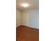 A bright bedroom featuring sleek wood flooring and a closet with paneled doors at 162 Odyssey Turn, Conyers, GA 30012