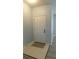 The home's entrance showcases a white door, light tile, and is illuminated by natural light at 162 Odyssey Turn, Conyers, GA 30012