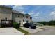 View of the back of the townhouses with private parking spots and grassy areas in between at 162 Odyssey Turn, Conyers, GA 30012