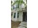 Two story home showcasing a beige exterior with black shutters and a small front lawn at 162 Odyssey Turn, Conyers, GA 30012
