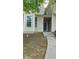 Two story townhome featuring beige siding with a front entrance leading up to the door at 162 Odyssey Turn, Conyers, GA 30012