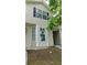 Front view of two-story town house, with neutral siding and black shutters at 162 Odyssey Turn, Conyers, GA 30012