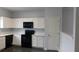 Well-kept kitchen provides white cabinets and tiled floor at 162 Odyssey Turn, Conyers, GA 30012