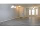 Light-filled living space with modern flooring, neutral walls, and contemporary lighting fixtures at 162 Odyssey Turn, Conyers, GA 30012