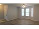 Bright living room boasts modern flooring and plenty of natural light at 162 Odyssey Turn, Conyers, GA 30012