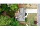 Aerial view of the home showcasing the roof, driveway, surrounding greenery, and the backyard deck at 1812 Riverton Dr, Suwanee, GA 30024