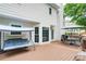 Backyard view of the deck with a dining table, umbrella and porch swing, perfect for outdoor relaxation and entertaining at 1812 Riverton Dr, Suwanee, GA 30024