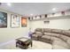 Finished basement with a sectional sofa, and movie posters for a cozy entertainment space at 1812 Riverton Dr, Suwanee, GA 30024
