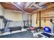 Unfinished basement gym area with exercise equipment including treadmill and weight machines at 1812 Riverton Dr, Suwanee, GA 30024
