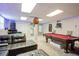 Finished basement featuring a pool table and a cozy lounge area with access to backyard at 1812 Riverton Dr, Suwanee, GA 30024
