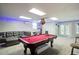 Finished basement features a pool table, lounge area, and walkout access to the backyard at 1812 Riverton Dr, Suwanee, GA 30024