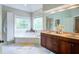Bright bathroom features a soaking tub and double sinks at 1812 Riverton Dr, Suwanee, GA 30024