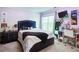 Stylish bedroom boasts a large window and modern décor at 1812 Riverton Dr, Suwanee, GA 30024