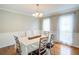Bright dining room featuring hardwood floors, natural light and seating for six at 1812 Riverton Dr, Suwanee, GA 30024