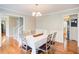 Bright dining room with hardwood floors, a chandelier, and seating for six at 1812 Riverton Dr, Suwanee, GA 30024