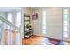 Inviting foyer with hardwood floors, a white front door and staircase, and decor at 1812 Riverton Dr, Suwanee, GA 30024