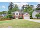 Charming two-story brick home with a well-maintained lawn and attached two-car garage at 1812 Riverton Dr, Suwanee, GA 30024